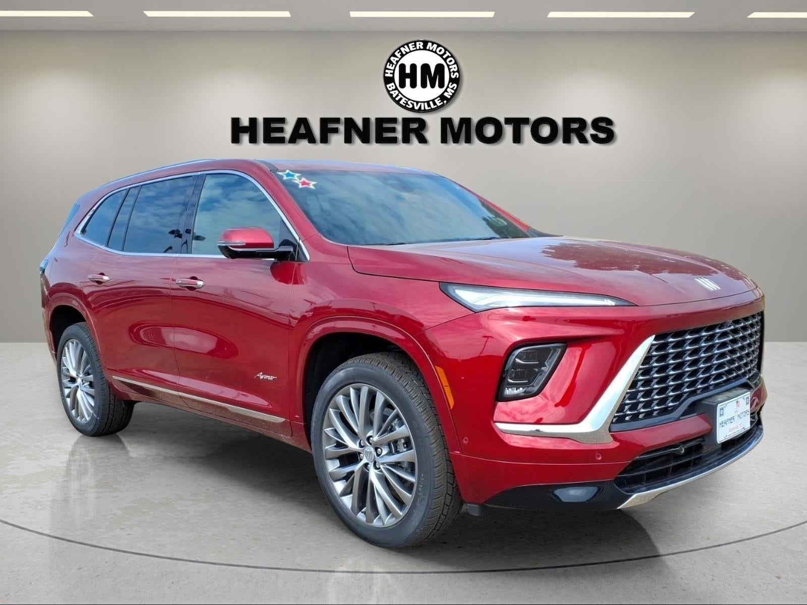 2026 Buick Enclave Avenir in Cherry Red Tintcoat — front three-quarter view